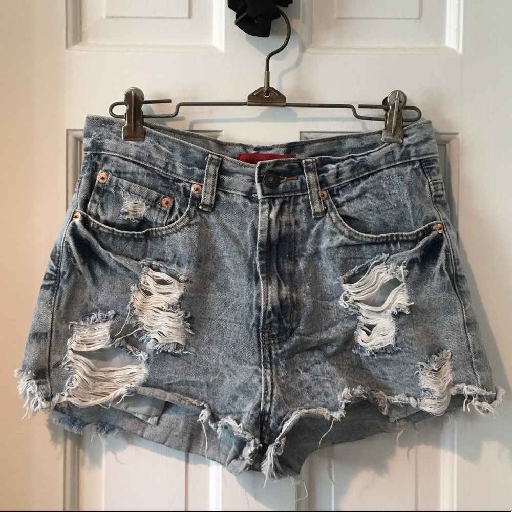 Medium rise distressed and ripped denim shorts